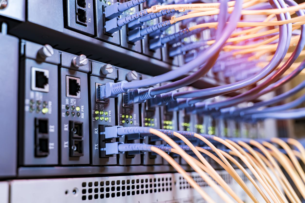 Fiber Optical cables connected to an optic ports and Network cables connected to ethernet ports